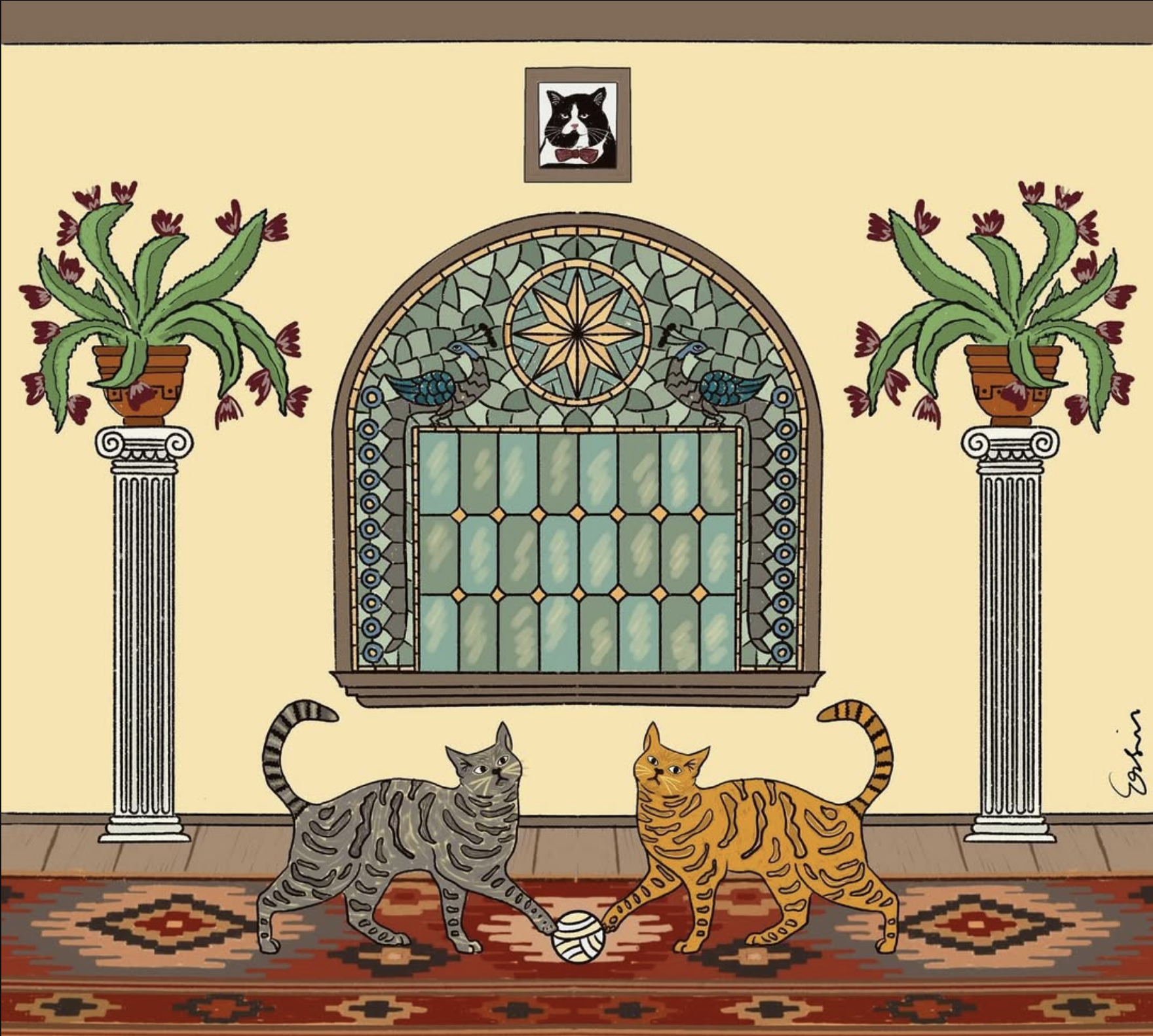 Anadolu motifli bir odada, halı üzerinde oynayan iki kedi